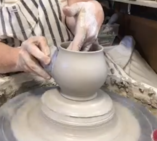 cori sandler pulling wall of a mug